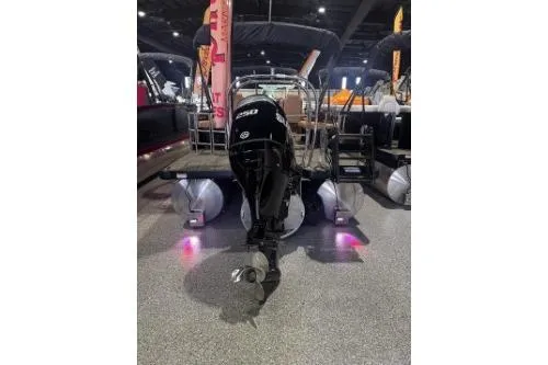 Slide: The Image of 2026 Godfrey Sweetwater 2286 SFLC pontoon boat with outboard motor, displayed indoors. - 7