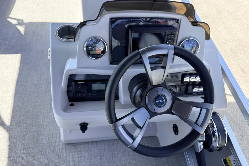 Slide: The Image of Steering console of 2026 Avalon 2385 Venture 85 Tri Toon boat, featuring modern controls. - 23