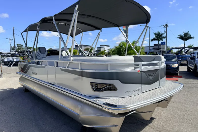Slide: The Image of 2026 Avalon 2385 Venture 85 Tri Toon boat with canopy, parked outdoors. - 5
