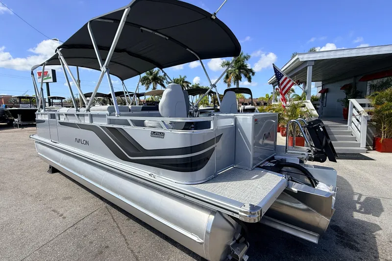 Slide: The Image of 2026 Avalon 2385 Venture 85 Tri Toon boat with canopy, parked outdoors. - 9