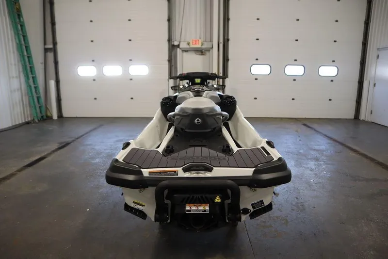 Slide: The Image of 2026 Sea-Doo GTX Limited 325 jet ski in a garage, rear view. - 3