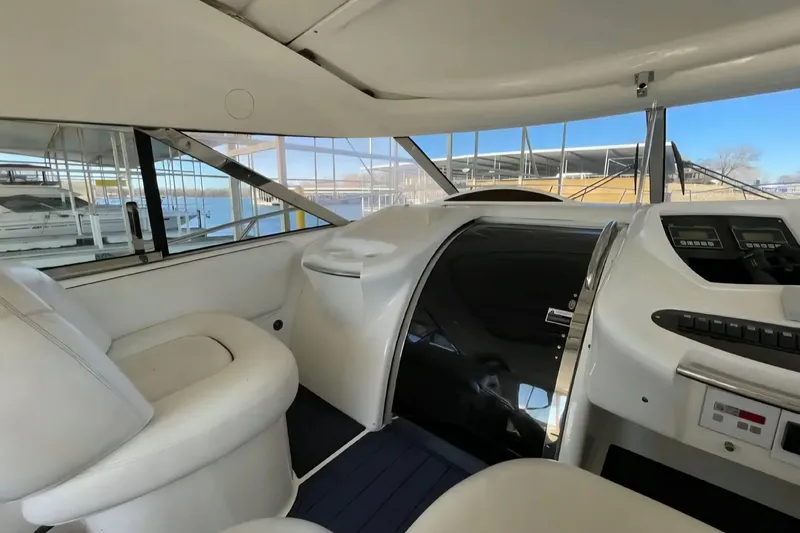 Slide: The Image of Interior of 2004 Sunseeker Predator 56 yacht with white seating and control panel. - 10