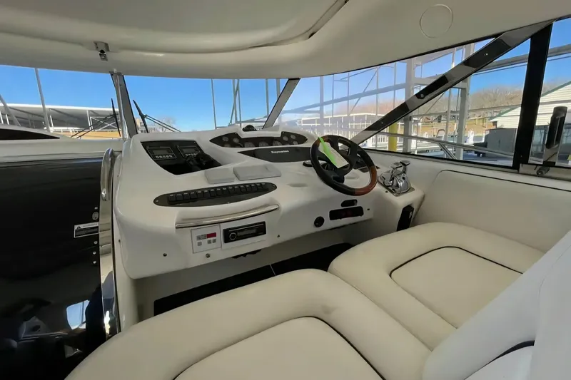 Slide: The Image of 2004 Sunseeker Predator 56 yacht helm with modern controls and comfortable seating. - 11