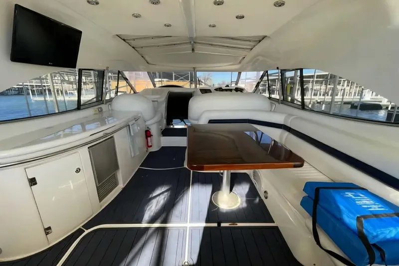 Slide: The Image of Interior of 2004 Sunseeker Predator 56 yacht with seating, table, and waterfront view. - 13