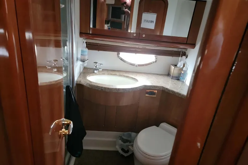 Slide: The Image of Luxurious bathroom in 2004 Sunseeker Predator 56 yacht with wooden cabinetry and modern fixtures. - 18
