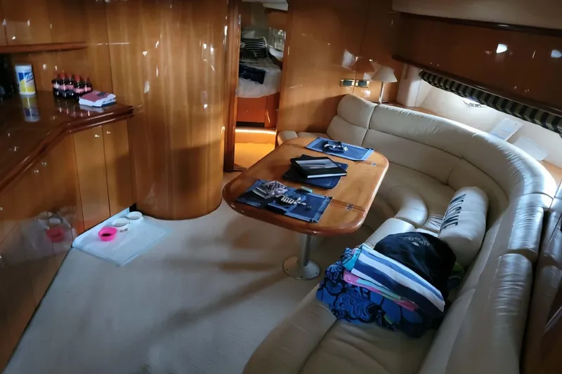 Slide: The Image of Luxurious interior of 2004 Sunseeker Predator 56 yacht with elegant seating and wooden finishes. - 19