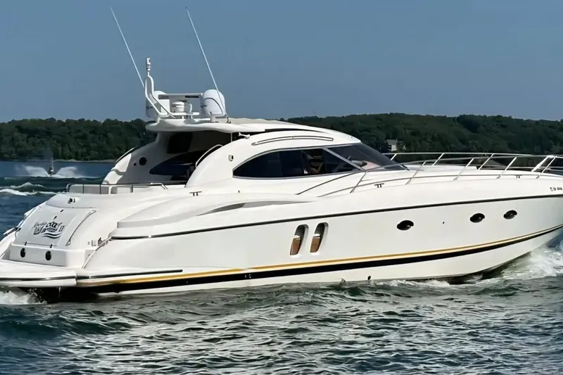 Slide: The Image of 2004 Sunseeker Predator 56 yacht cruising on a scenic lake. - 2