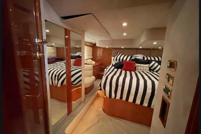 Slide: The Image of Luxurious cabin interior of 2004 Sunseeker Predator 56 yacht with striped bedding. - 20