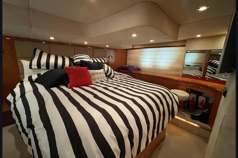 Slide: The Image of Luxurious cabin interior of 2004 Sunseeker Predator 56 yacht with striped bedding. - 21