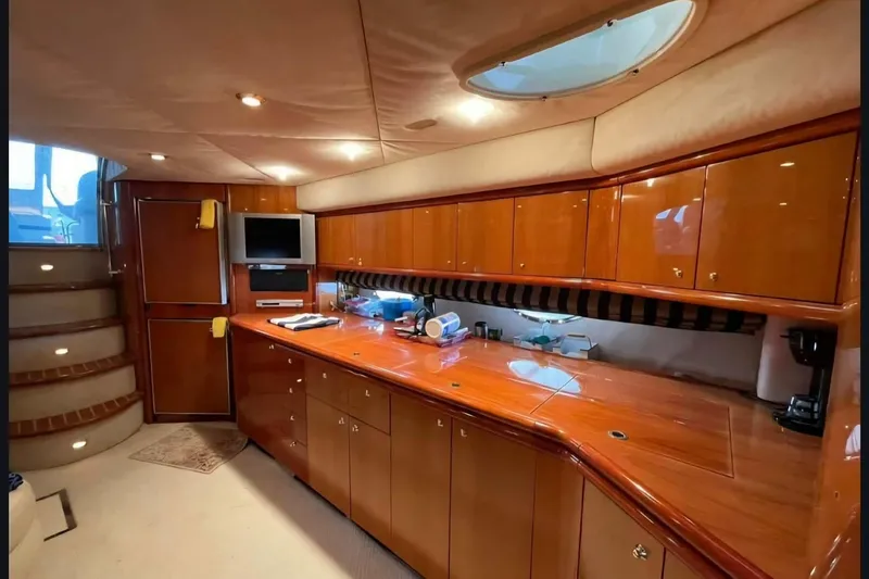 Slide: The Image of Luxurious interior of 2004 Sunseeker Predator 56 yacht with polished wood cabinetry. - 26