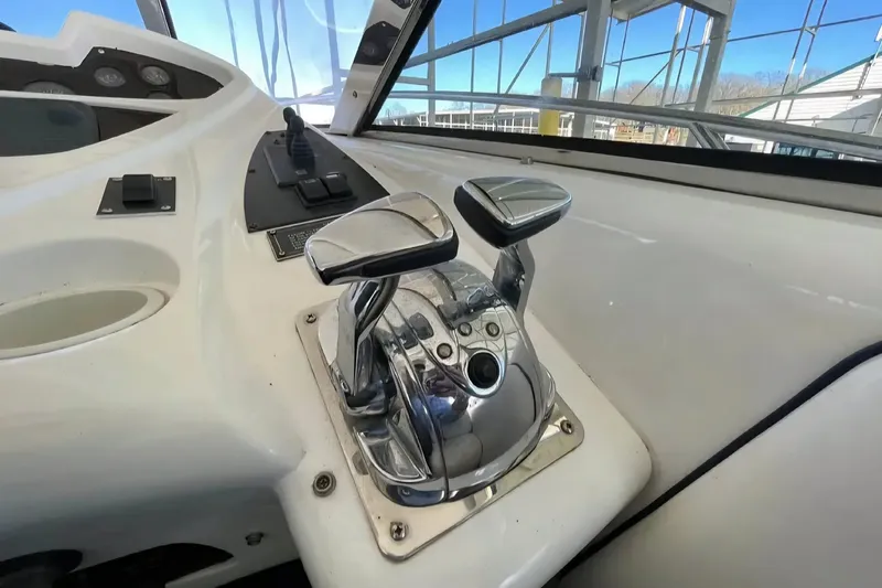 Slide: The Image of Control panel of a 2004 Sunseeker Predator 56 yacht, featuring sleek throttle levers. - 7