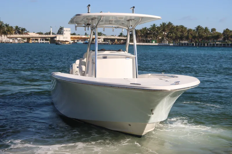 Slide: The Image of 2016 Southport 272 TE boat cruising on clear blue water. - 13