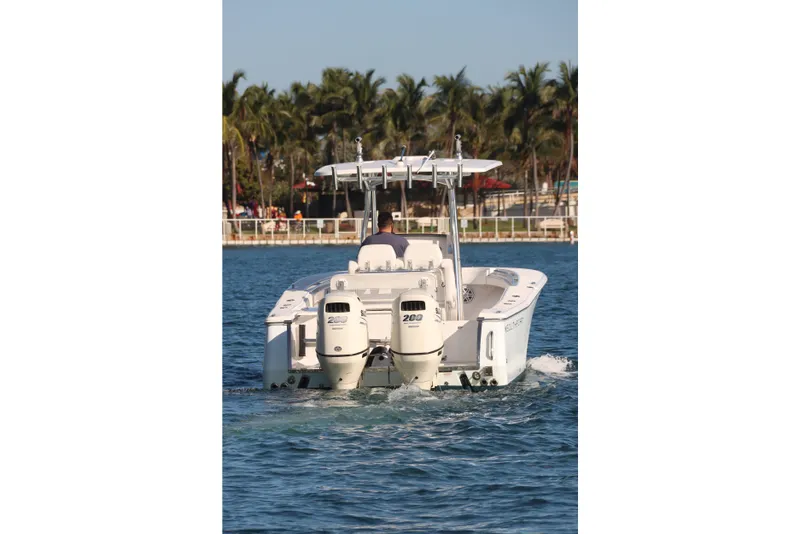 Slide: The Image of 2016 Southport 272 TE boat cruising on a sunny day near palm trees. - 14