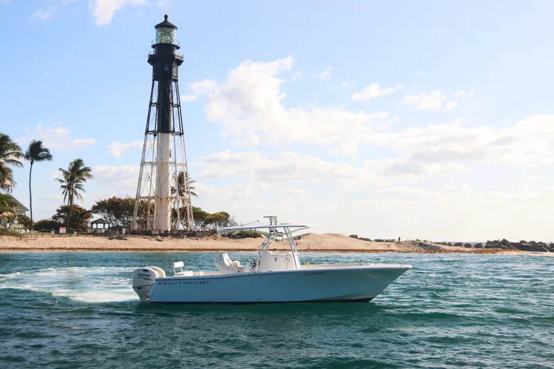 Slide: The Image of 2016 Southport 272 TE boat cruising near a lighthouse on a sunny day. - 19