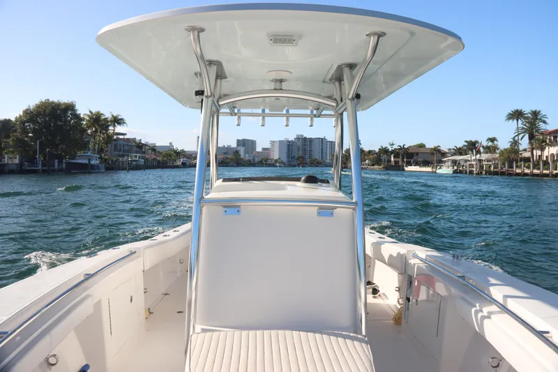 Slide: The Image of 2016 Southport 272 TE boat cruising on a scenic waterway with city skyline. - 21