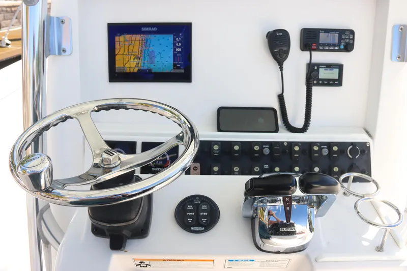 Slide: The Image of Steering console of 2016 Southport 272 TE boat with navigation and communication equipment. - 26