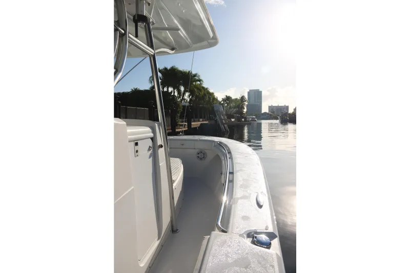 Slide: The Image of 2016 Southport 272 TE boat docked by a sunny waterfront with city skyline. - 29