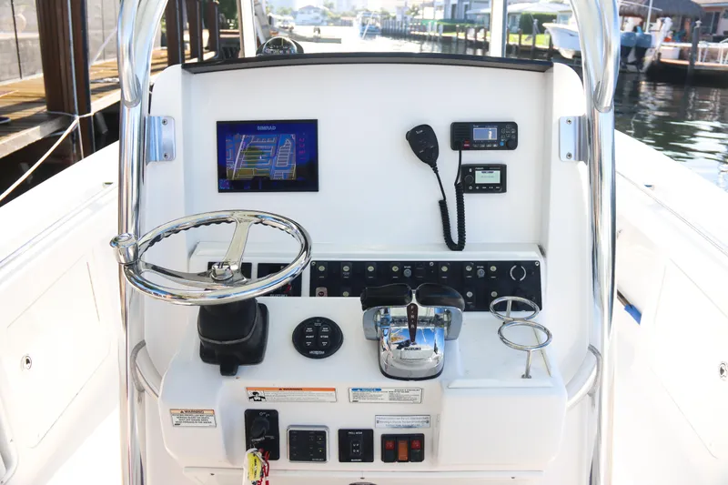 Slide: The Image of 2016 Southport 272 TE boat console with steering wheel, controls, and navigation equipment. - 30
