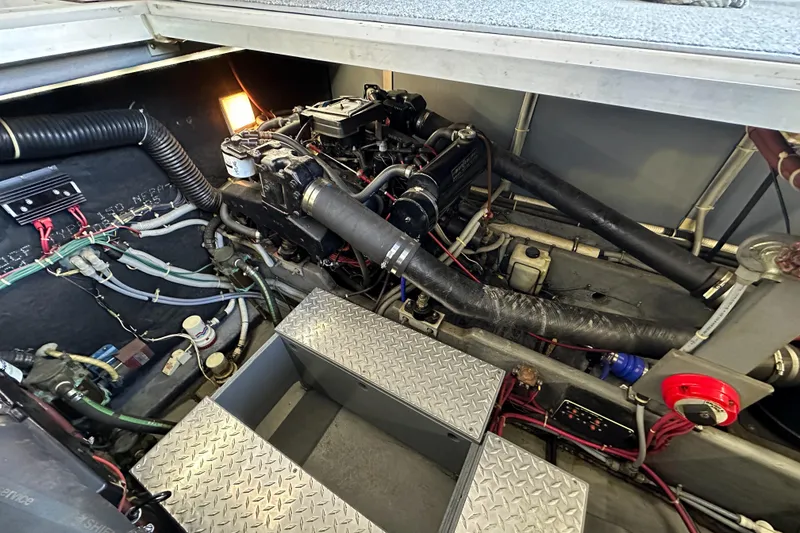 Slide: The Image of Engine compartment of a 1986 Sea Ray 390 Express Cruiser with visible wiring and components. - 12