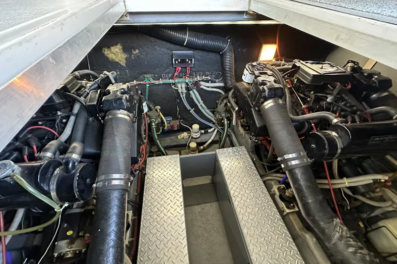 Slide: The Image of Engine compartment of a 1986 Sea Ray 390 Express Cruiser, showcasing dual engines and mechanical components. - 14
