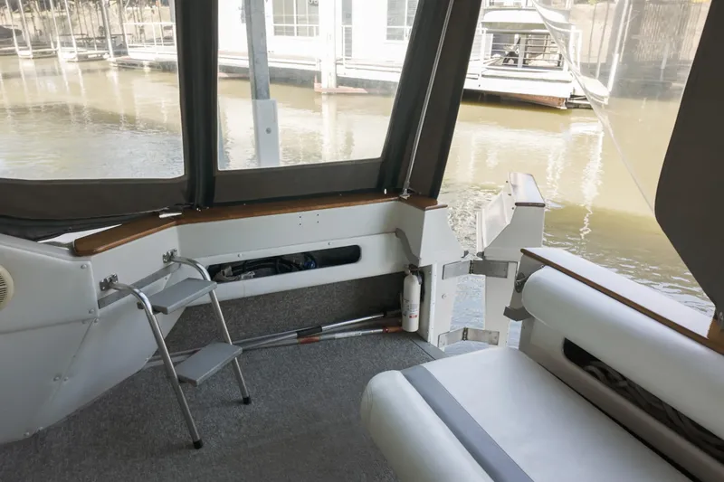 Slide: The Image of 1986 Sea Ray 390 Express Cruiser interior with seating and water view. - 16
