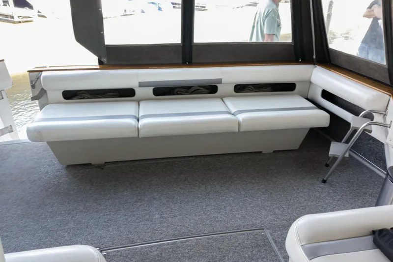 Slide: The Image of 1986 Sea Ray 390 Express Cruiser interior with white seating and carpeted floor. - 17