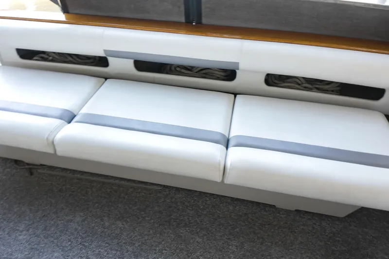 Slide: The Image of 1986 Sea Ray 390 Express Cruiser interior seating with storage compartments. - 18