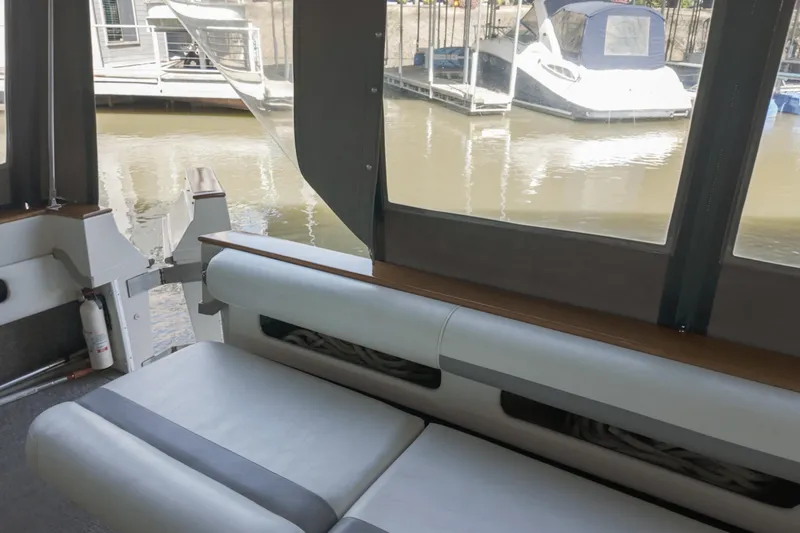 Slide: The Image of 1986 Sea Ray 390 Express Cruiser interior with marina view through windows. - 19