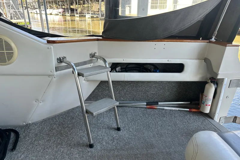 Slide: The Image of 1986 Sea Ray 390 Express Cruiser interior with ladder and fire extinguisher. - 21