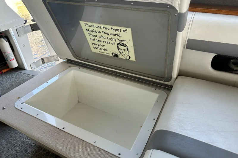 Slide: The Image of Open storage compartment on 1986 Sea Ray 390 Express Cruiser with humorous sign inside. - 22