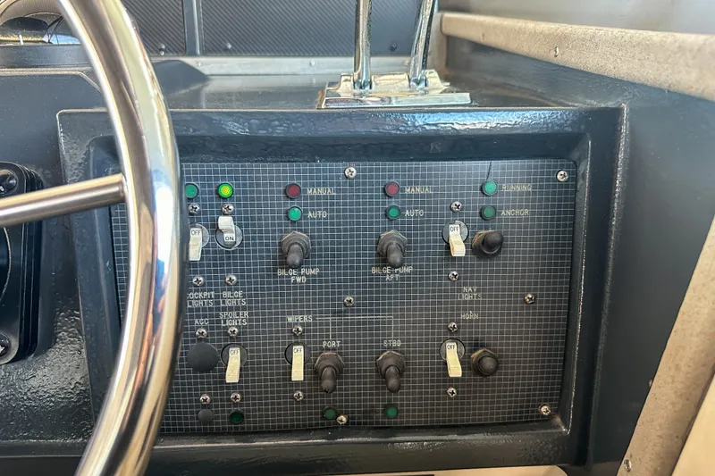 Slide: The Image of Control panel of a 1986 Sea Ray 390 Express Cruiser with switches and indicators. - 27