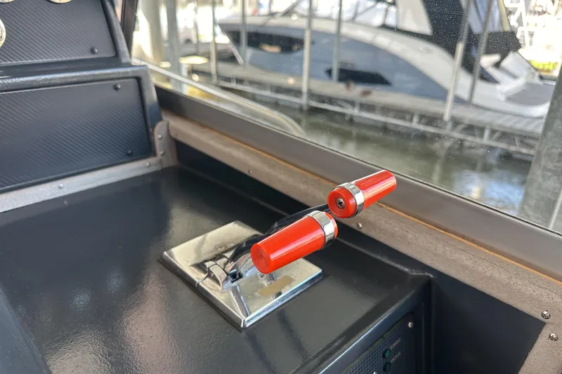 Slide: The Image of Throttle control lever on 1986 Sea Ray 390 Express Cruiser, docked with boats in background. - 28
