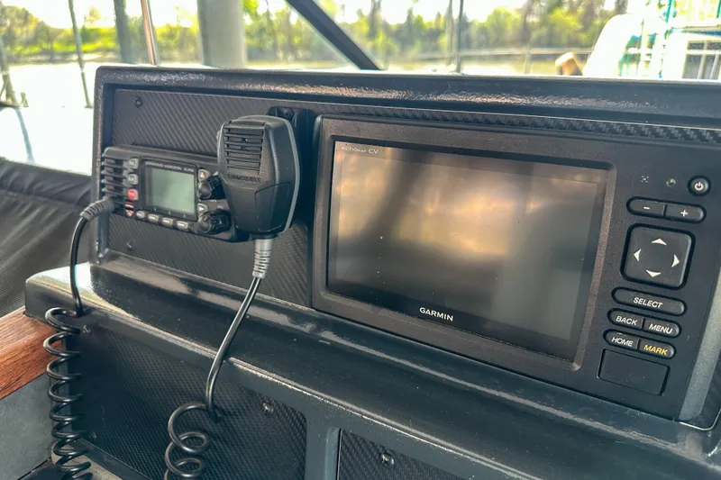 Slide: The Image of Control panel of a 1986 Sea Ray 390 Express Cruiser with Garmin navigation system. - 32