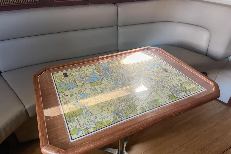 Slide: The Image of Nautical-themed table with map in 1986 Sea Ray 390 Express Cruiser cabin. - 36