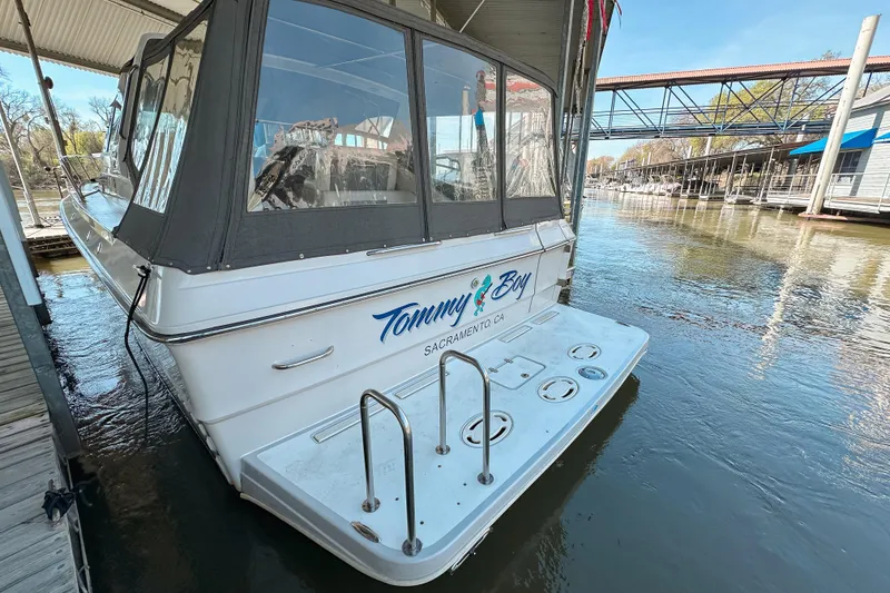 Slide: The Image of 1986 Sea Ray 390 Express Cruiser docked at marina, rear view. - 4
