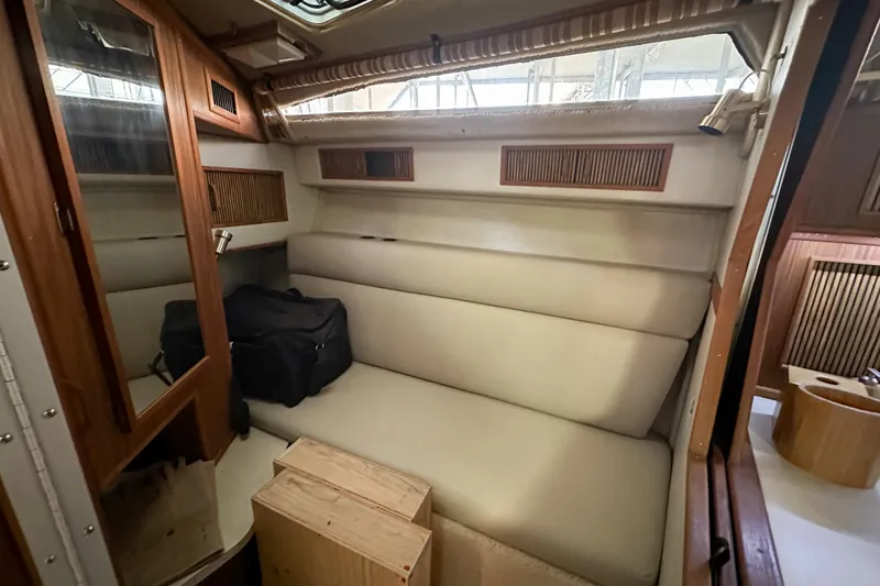 Slide: The Image of 1986 Sea Ray 390 Express Cruiser interior with beige seating and wooden accents. - 41