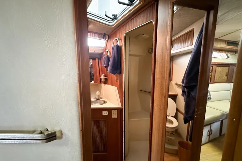 Slide: The Image of Interior of 1986 Sea Ray 390 Express Cruiser, featuring bathroom and seating area. - 44