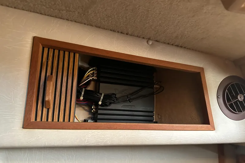 Slide: The Image of 1986 Sea Ray 390 Express Cruiser interior with audio equipment and ventilation. - 49