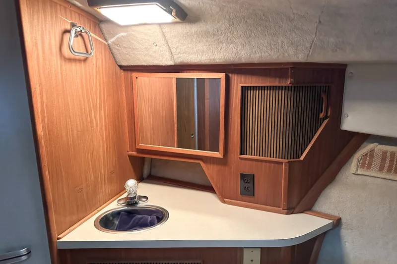 Slide: The Image of 1986 Sea Ray 390 Express Cruiser bathroom with wooden cabinetry and sink. - 54