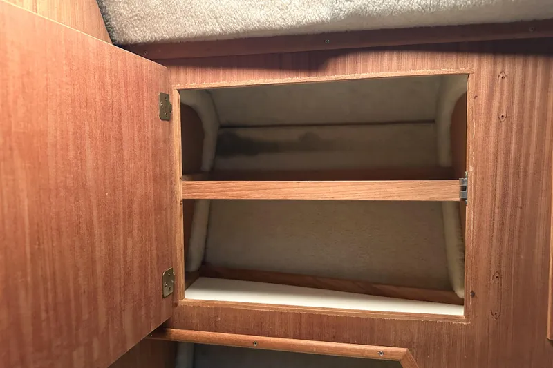 Slide: The Image of Open wooden cabinet inside 1986 Sea Ray 390 Express Cruiser boat. - 56