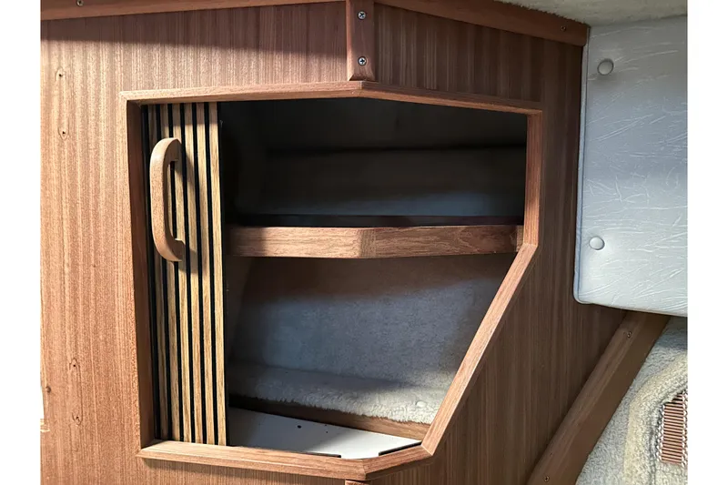 Slide: The Image of Wooden cabinet interior on a 1986 Sea Ray 390 Express Cruiser boat. - 58