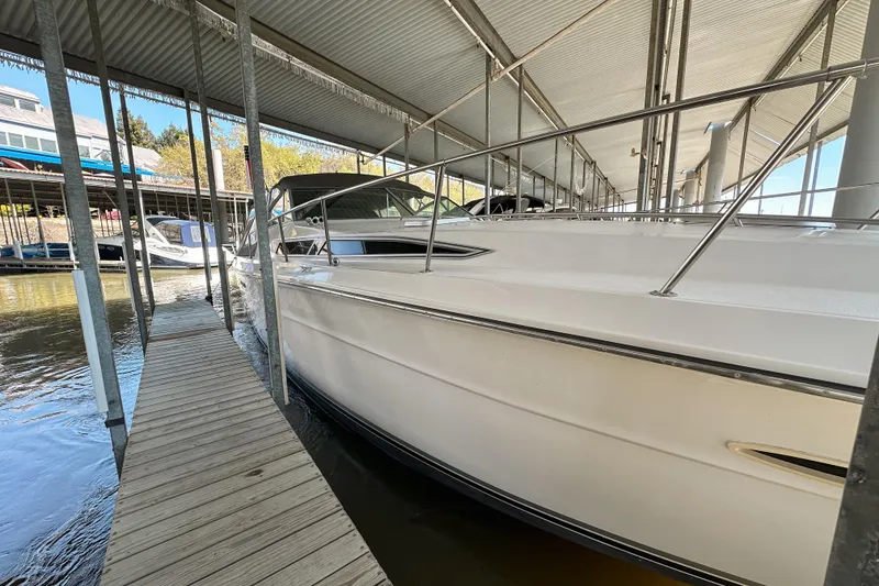 Slide: The Image of 1986 Sea Ray 390 Express Cruiser docked under covered marina. - 7