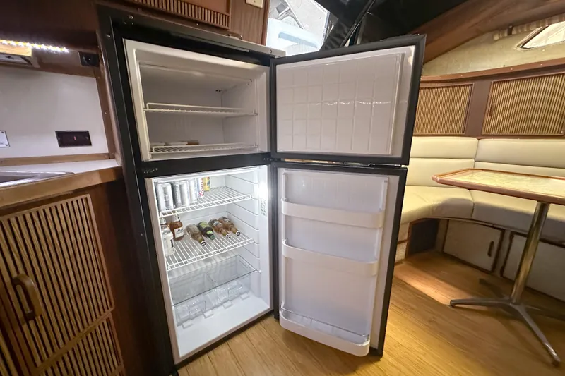 Slide: The Image of Open refrigerator inside 1986 Sea Ray 390 Express Cruiser yacht cabin. - 71