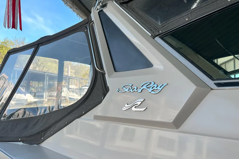 Slide: The Image of 1986 Sea Ray 390 Express Cruiser with logo and window detail. - 9