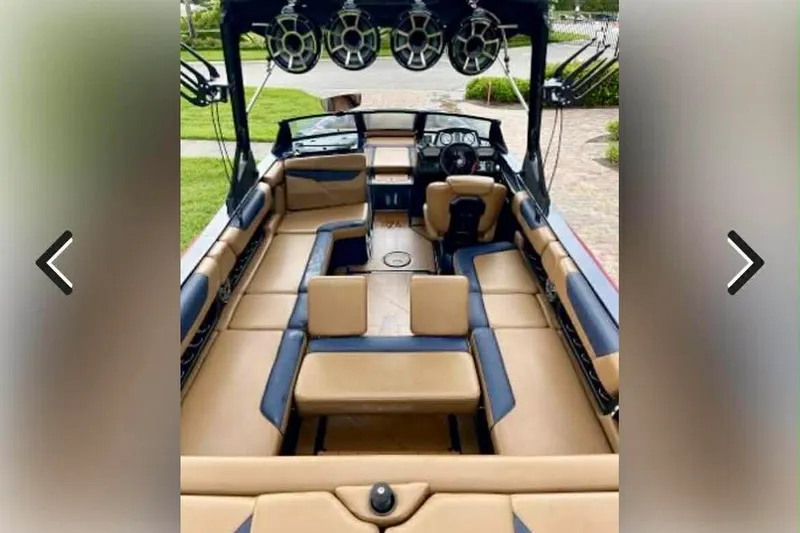 Slide: The Image of 2021 Axis A24 boat interior with tan and black seating, featuring overhead speakers. - 4