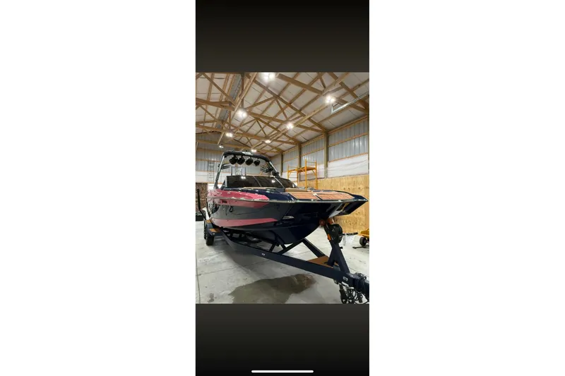 Slide: The Image of 2021 Axis A24 boat in a warehouse, showcasing sleek design and modern features. - 6
