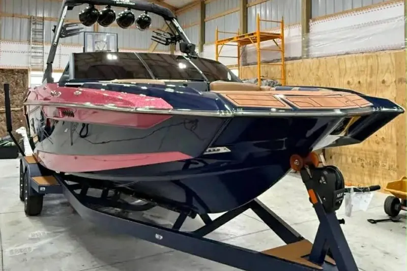 Slide: The Image of 2021 Axis A24 boat on trailer in a warehouse setting. - 8