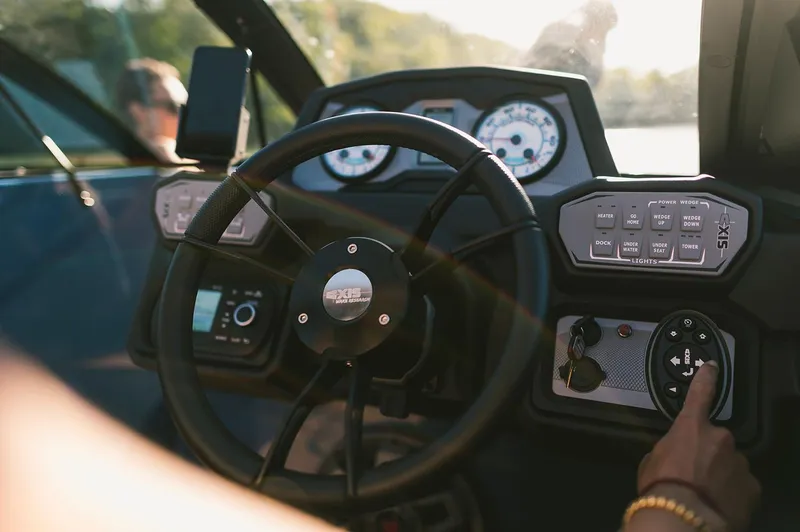 Slide: The Image of Manufacturer Provided Image: 2021 Axis A24 boat dashboard with steering wheel and control panel. - 9