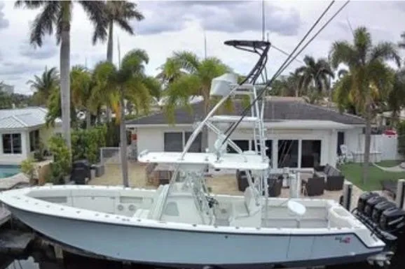 Slide: The Image of 2017 SeaVee 390Z boat docked near a tropical waterfront home with palm trees. - 3
