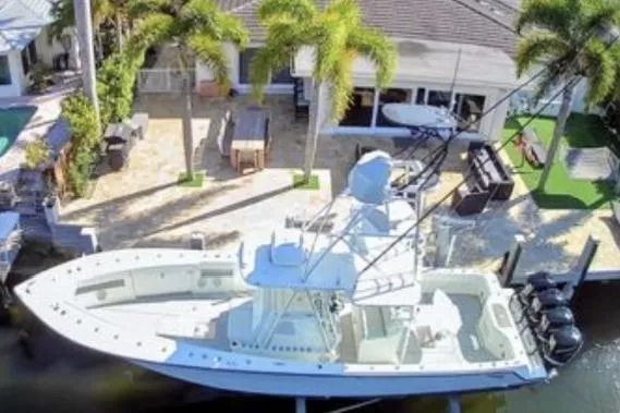 Slide: The Image of 2017 SeaVee 390Z boat docked by a waterfront home with palm trees. - 4
